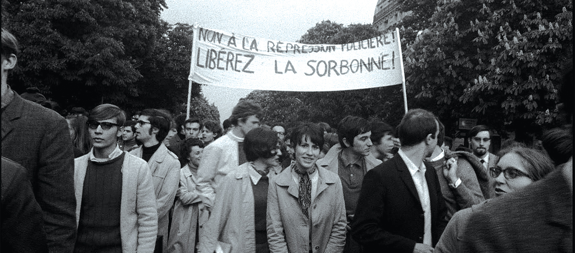 men and women demonstration, holding a banner