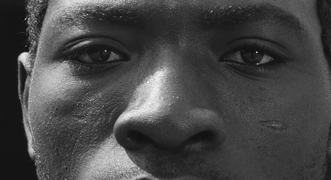 A closeup of a black man's face in a scene from the 1975 African film Muna Moto