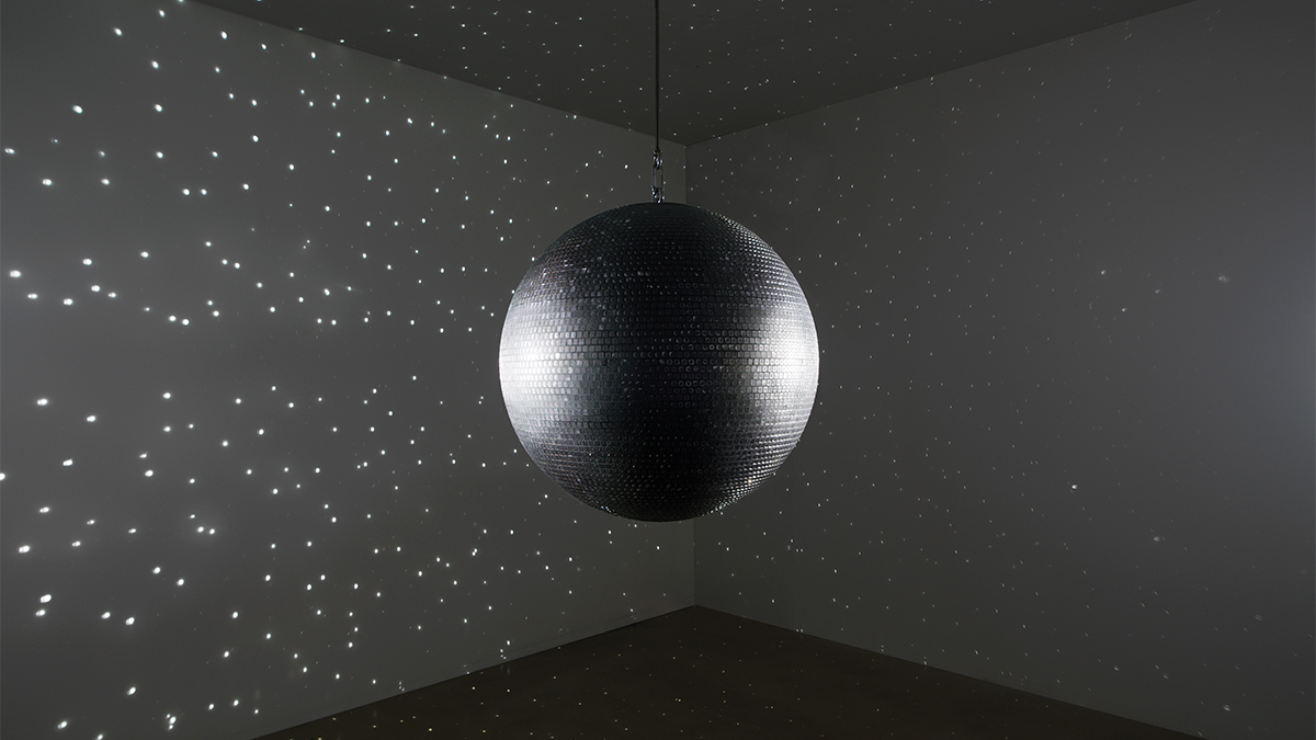 disco ball artwork casting light across a room
