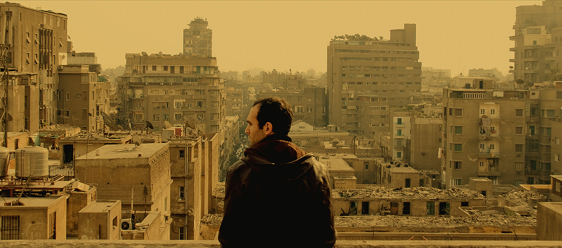 Man stands in front of cityscape 