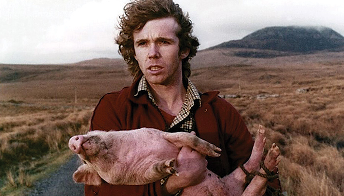 Man holding pig