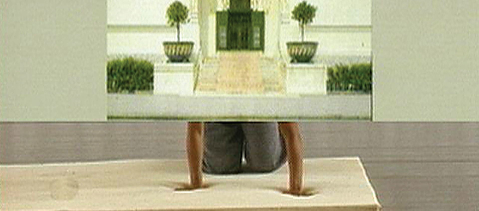 Person kneels behind screen