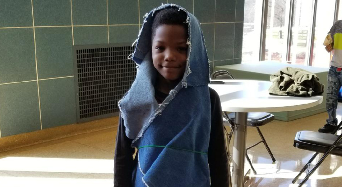 A child wraps himself in fabric