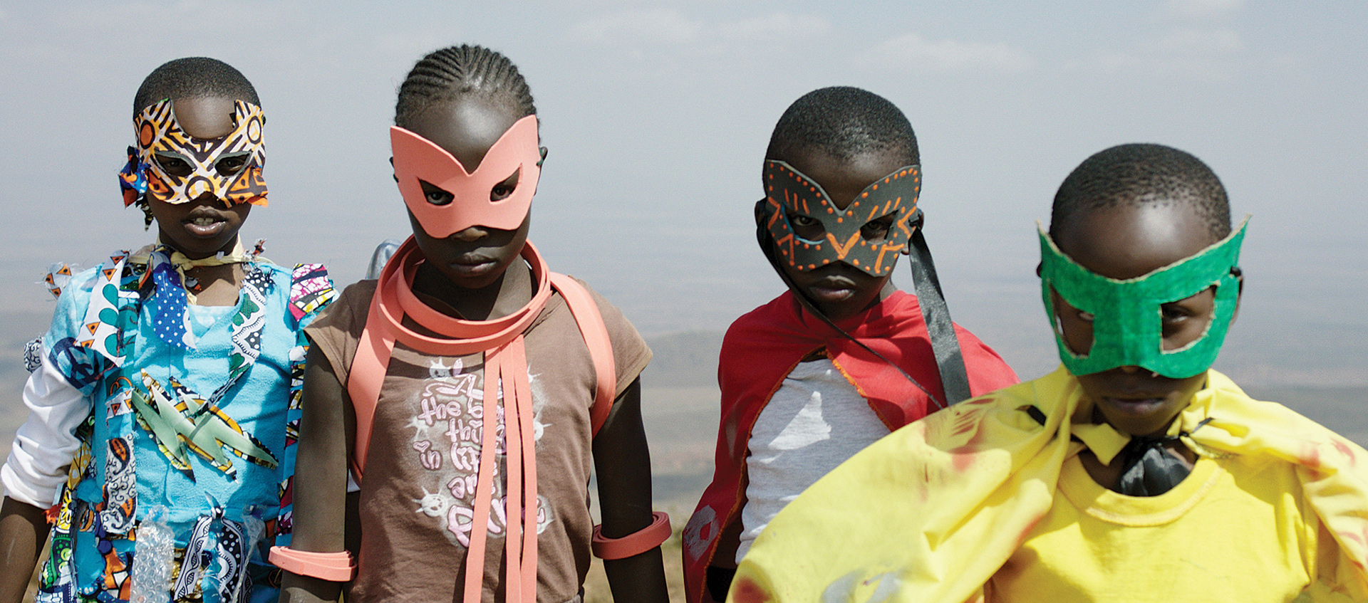 Four young Kenyan children in makeshift masks and superhero costumes, from the film Supa Modo