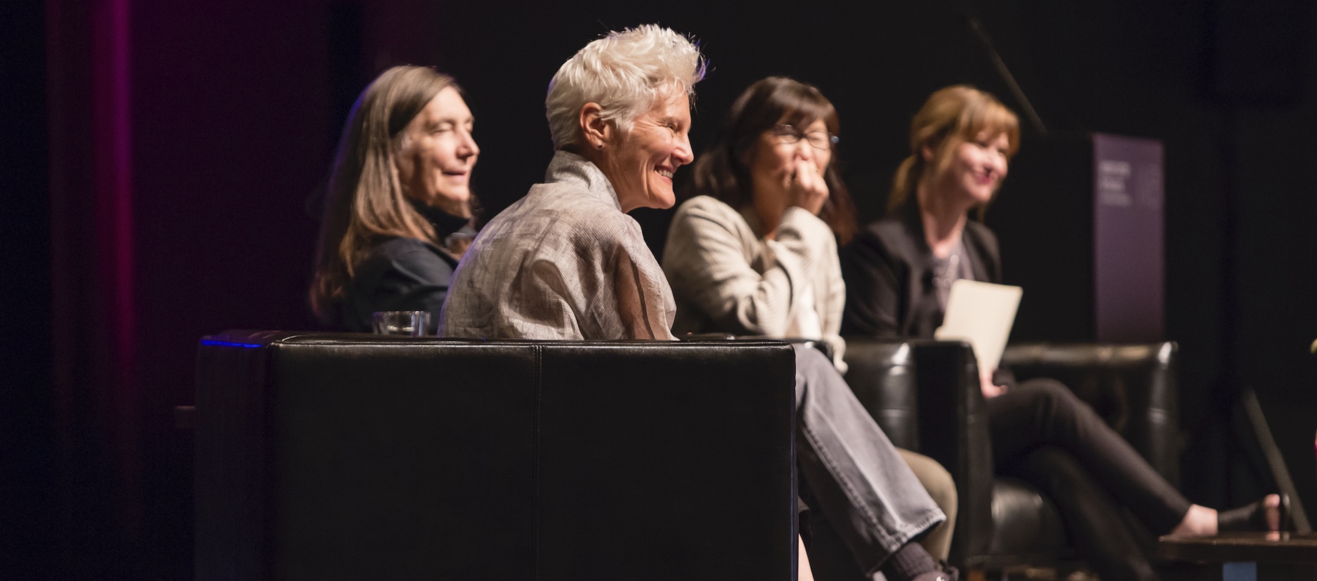 Artists Ann Hamilton, Jenny Holzer, and Maya Lin sitting on the stage of Mershon Auditorium, discussing their work with Wexner Center director Johann Burton as part of opening events for the fall 2019 exhibition HERE at the Wexner Center for the Arts. Photo by Katie Gentry