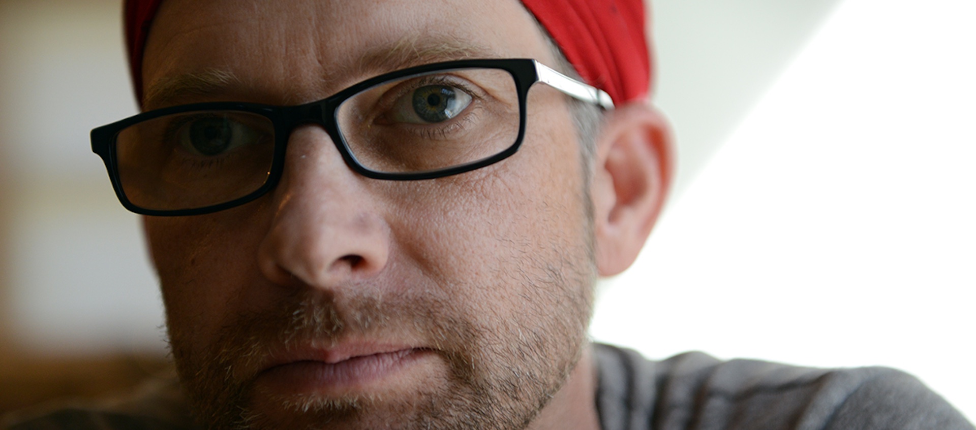 A close-up head shot of artist, activist and Ohio University professor John Sabraw