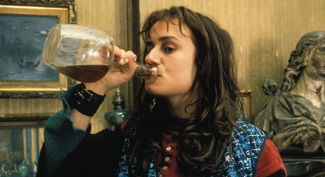 Actress Sandrine Bonnaire drinks from a large bottle in Agnes Varda's film Vagabond