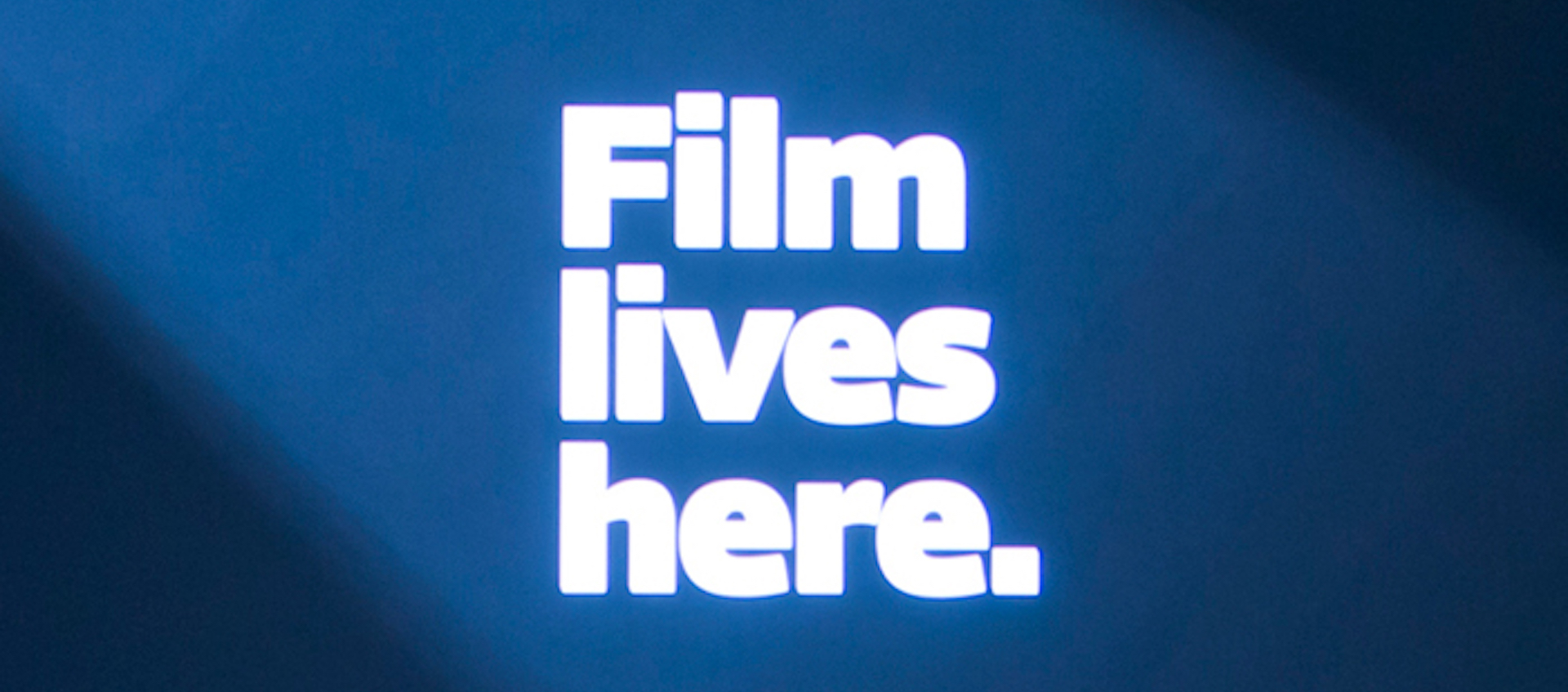 White text on blue background with the Wexner Center Film/Video tagline Film Lives Here