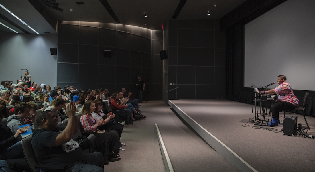 Columbus musician Sharon Udoh performs for high school students in the Film/Video Theater of the Wexner Center for the Arts in January 2020