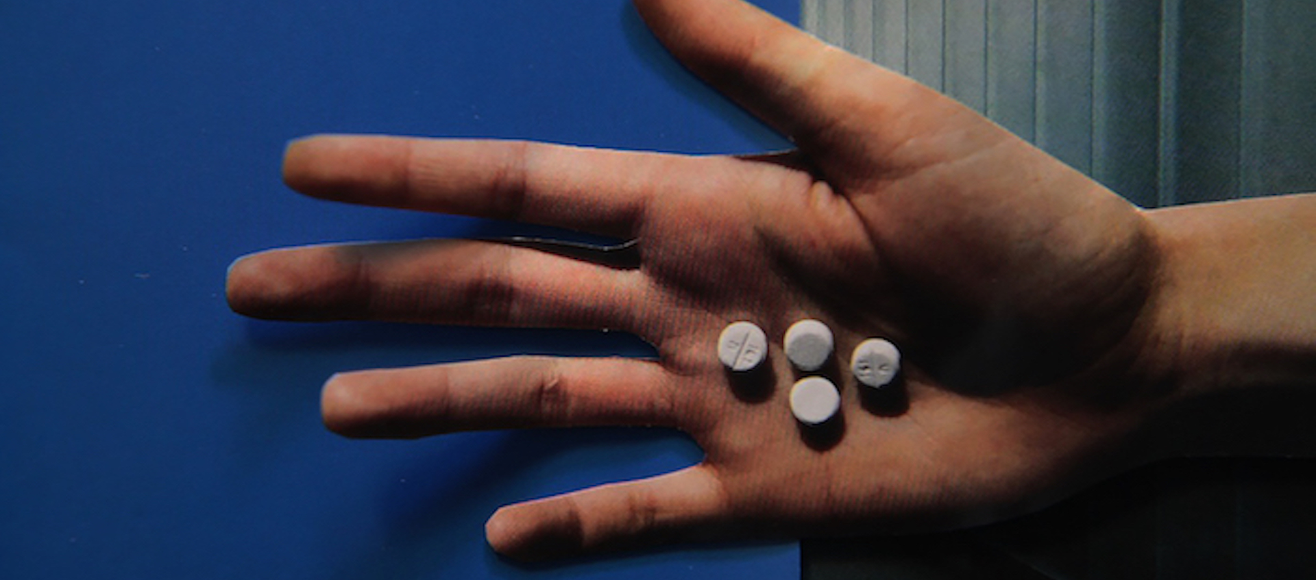 Hand holding pills from Lewis Klahr's Circumstantial Pleasures