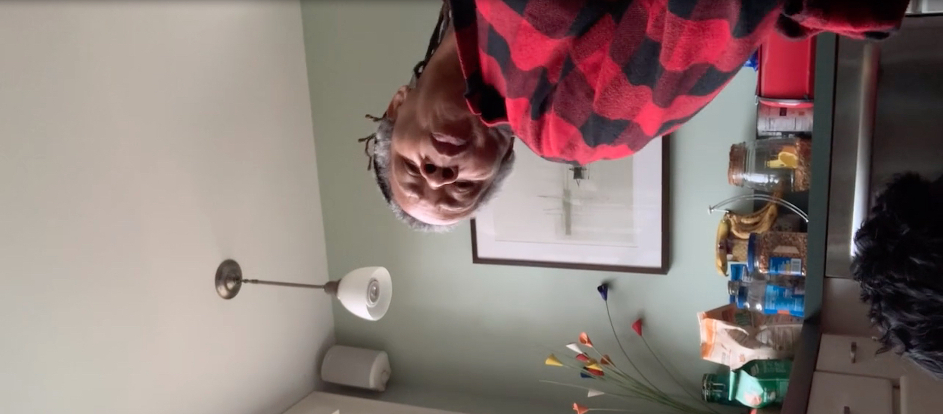 Dancer and choreographer Bebe Miller performs a movement work in her home, captured on a phone attached to her foot, which turns the view of the room sideways