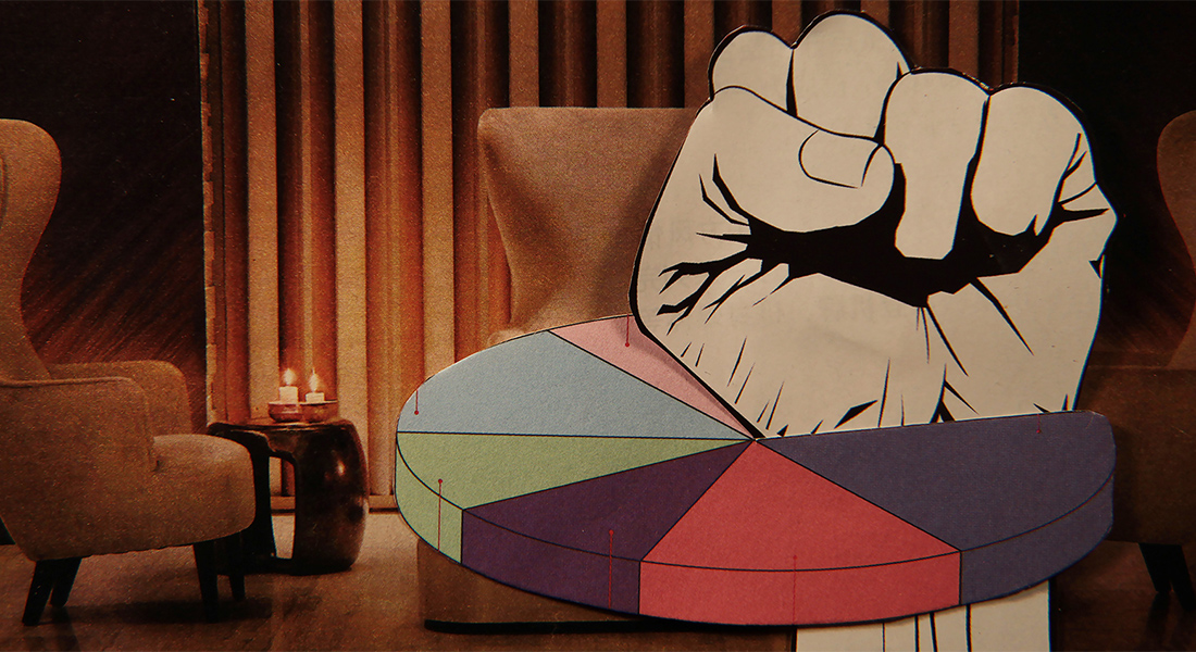 In this color collage, a still from the film, a paper fist punches through a pie chart with a vintage lounge setting as the background.
