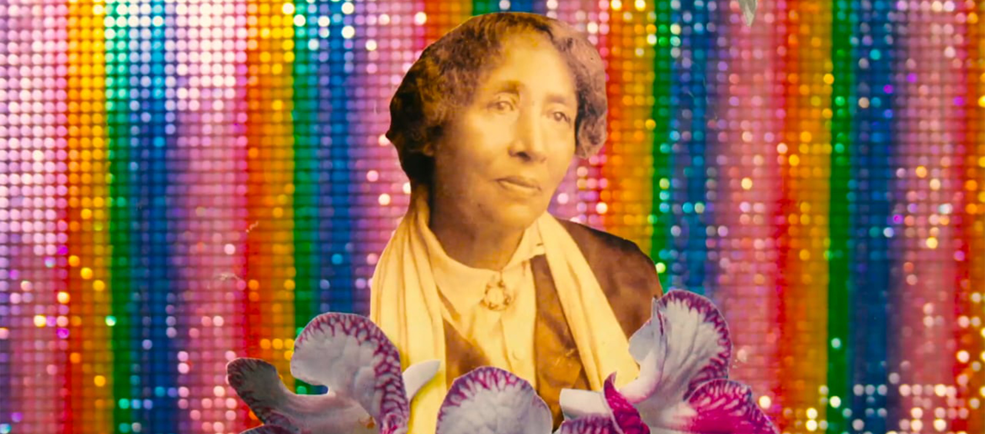 A vintage sepia image of a woman holding white and violet orchids against a sequined rainbow background