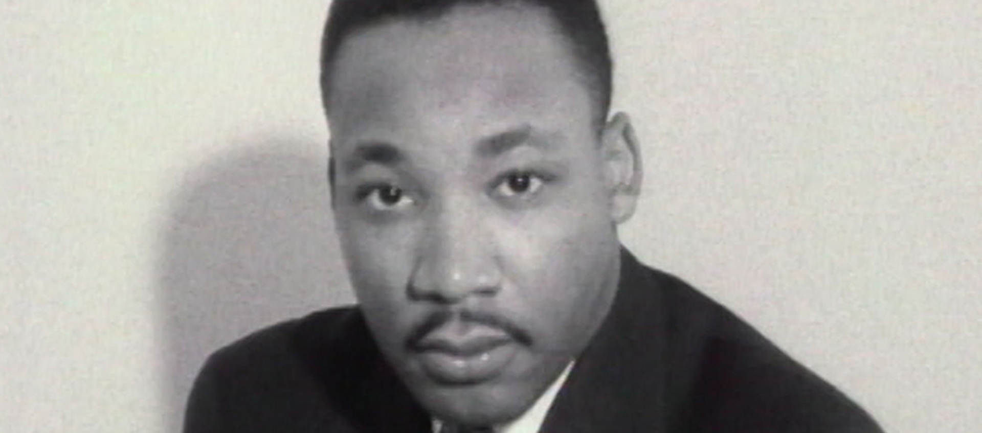 Black & white photo of Martin Luther King, Jr. looking at the camera