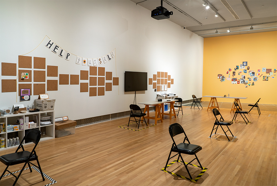 Chairs, artwork, and worktables fill the gallery