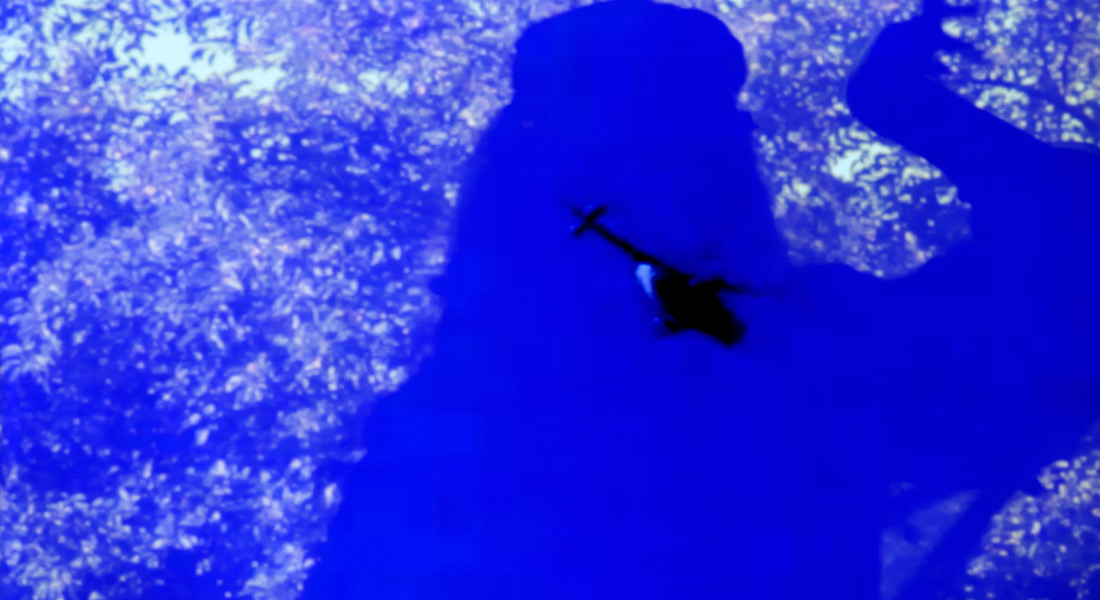 A shadowy helicopter is seen in an almost abstract photo